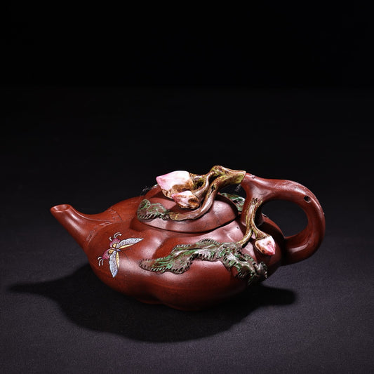 A red clay painted purple clay teapot