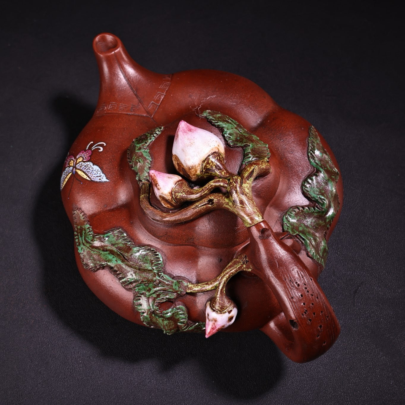 A red clay painted purple clay teapot