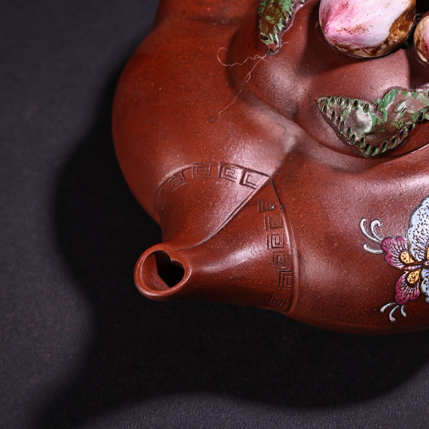 A red clay painted purple clay teapot