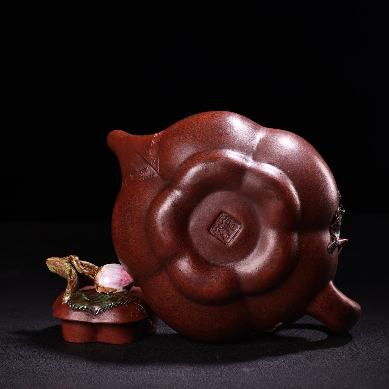 A red clay painted purple clay teapot