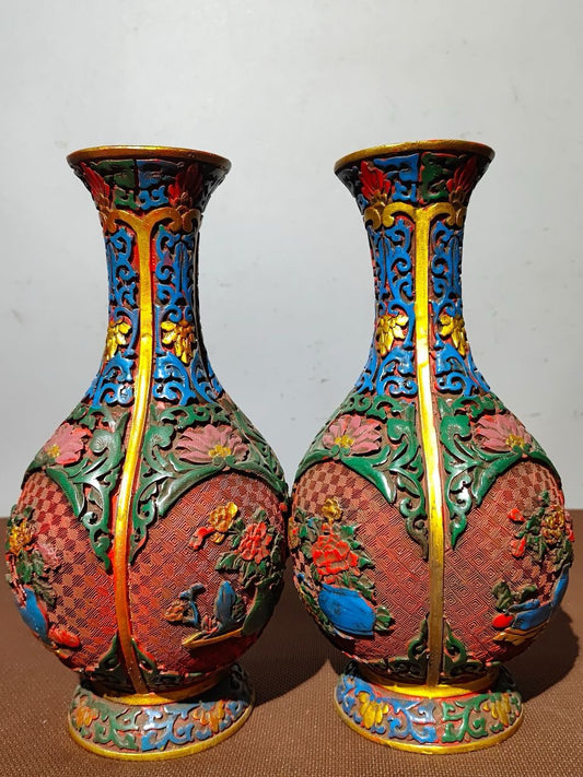 A pair of red lacquerware bottles