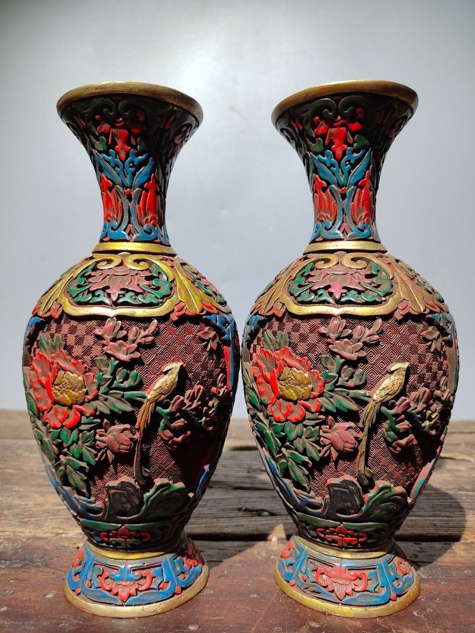 A pair of red lacquerware bottles