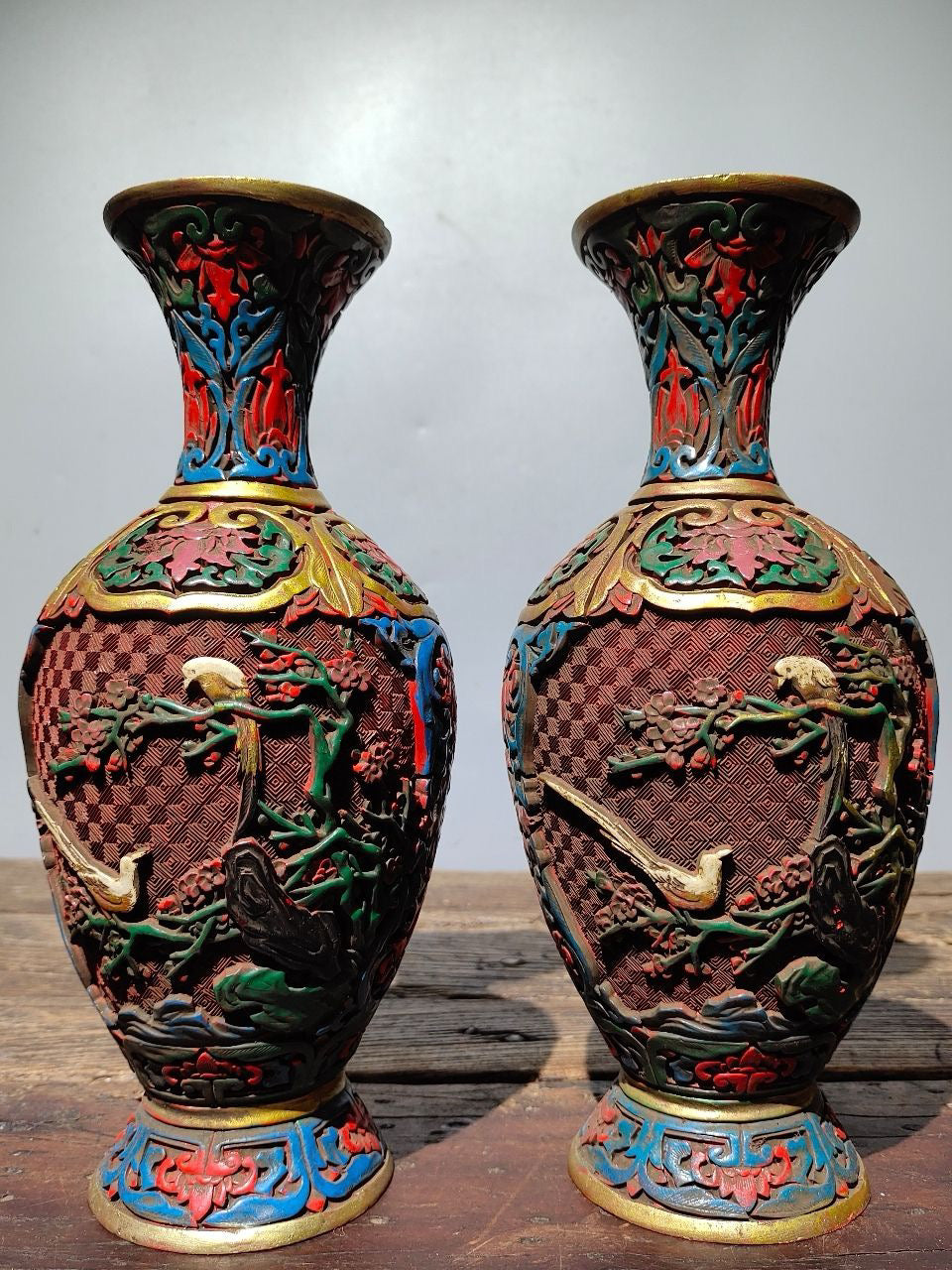A pair of red lacquerware bottles