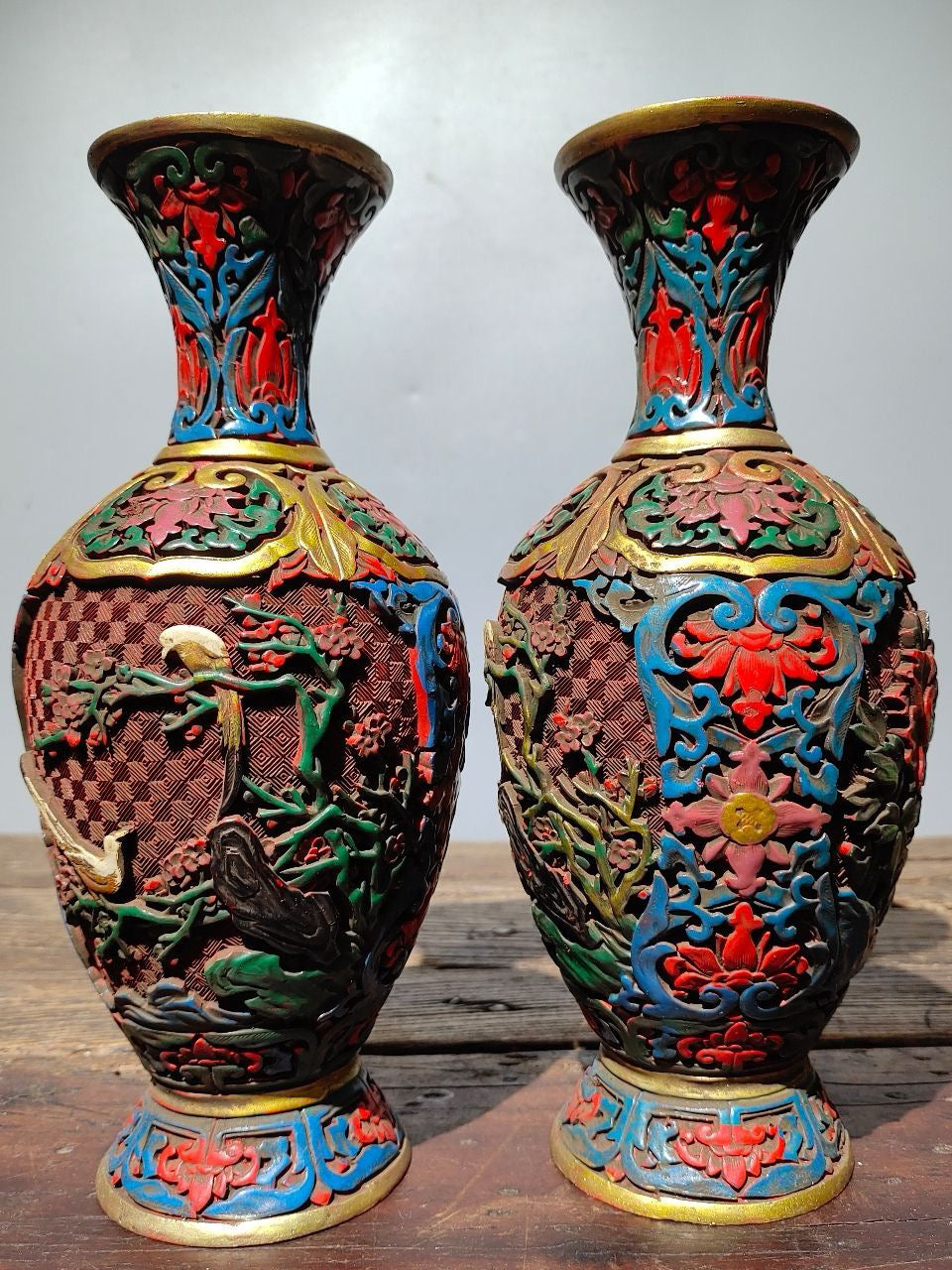 A pair of red lacquerware bottles
