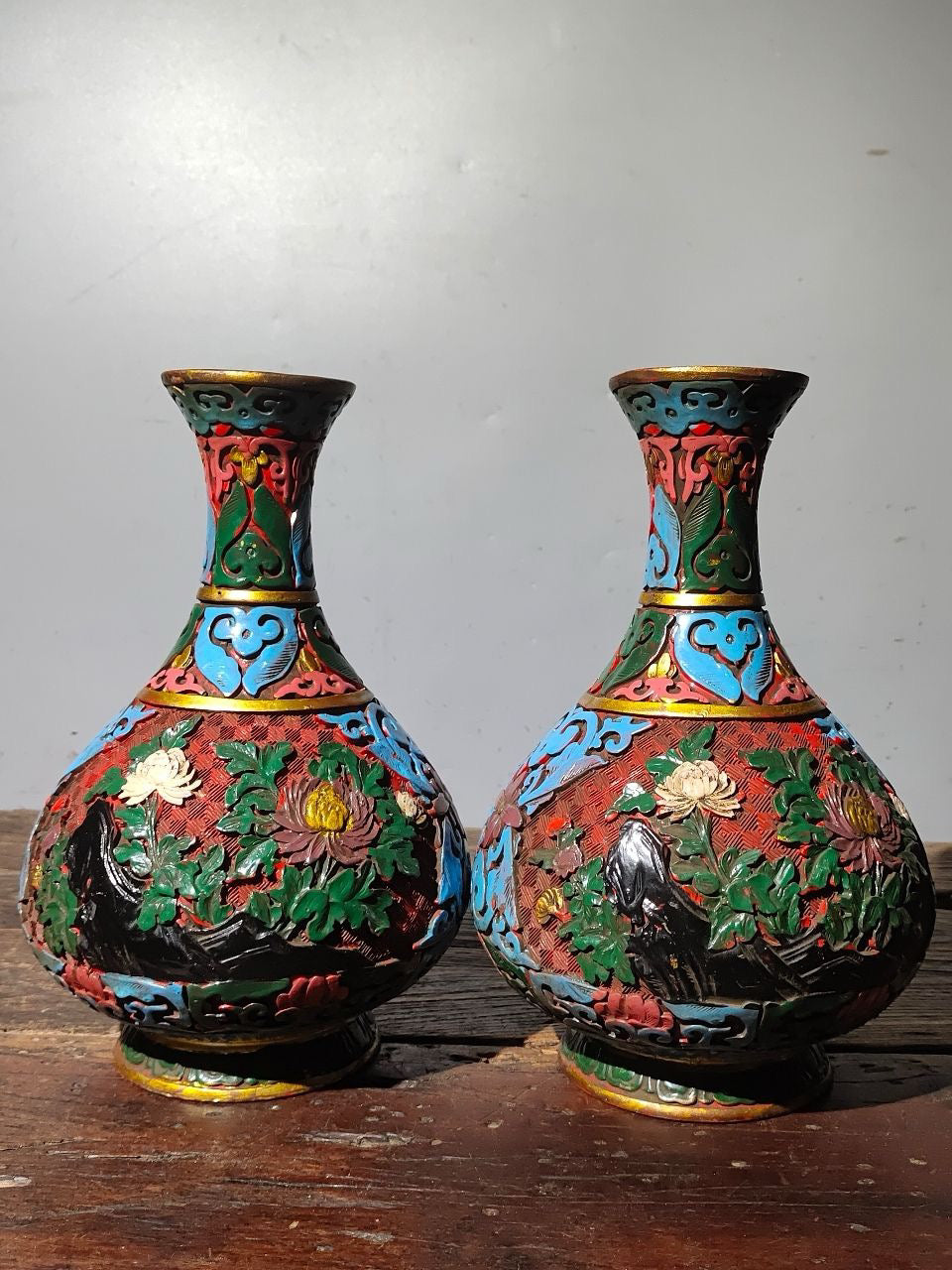A pair of red lacquerware bottles