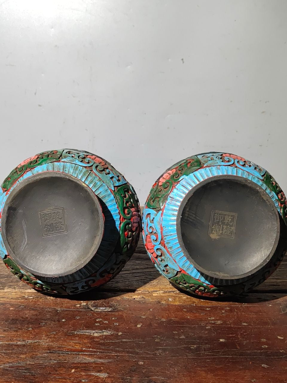 A pair of red lacquerware bottles