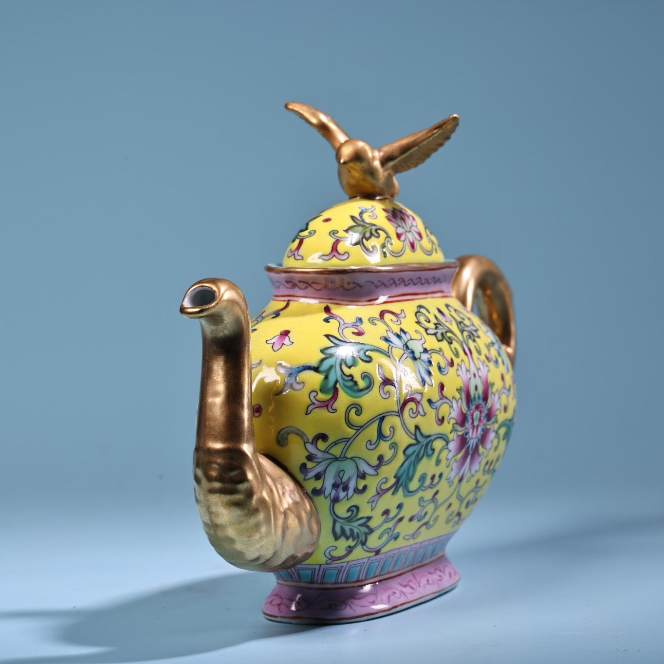 Hand painted enamel gilded gold colored porcelain teapot