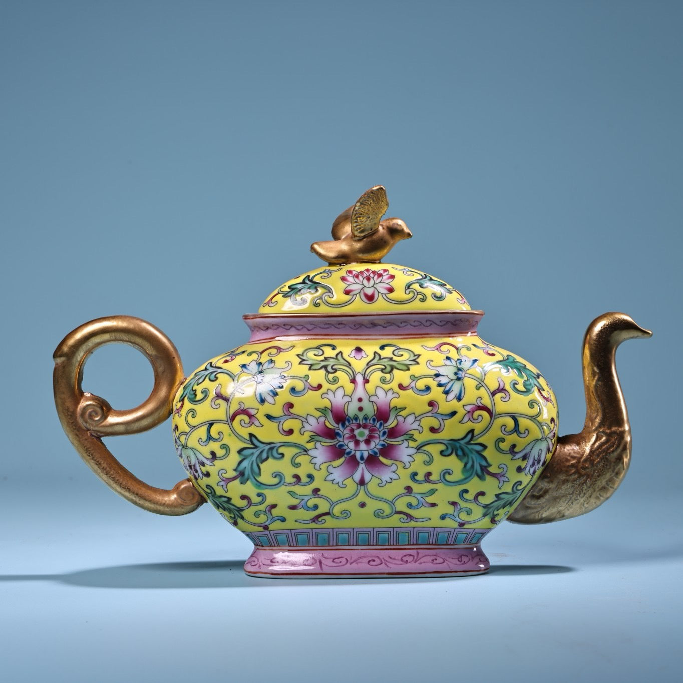 Hand painted enamel gilded gold colored porcelain teapot