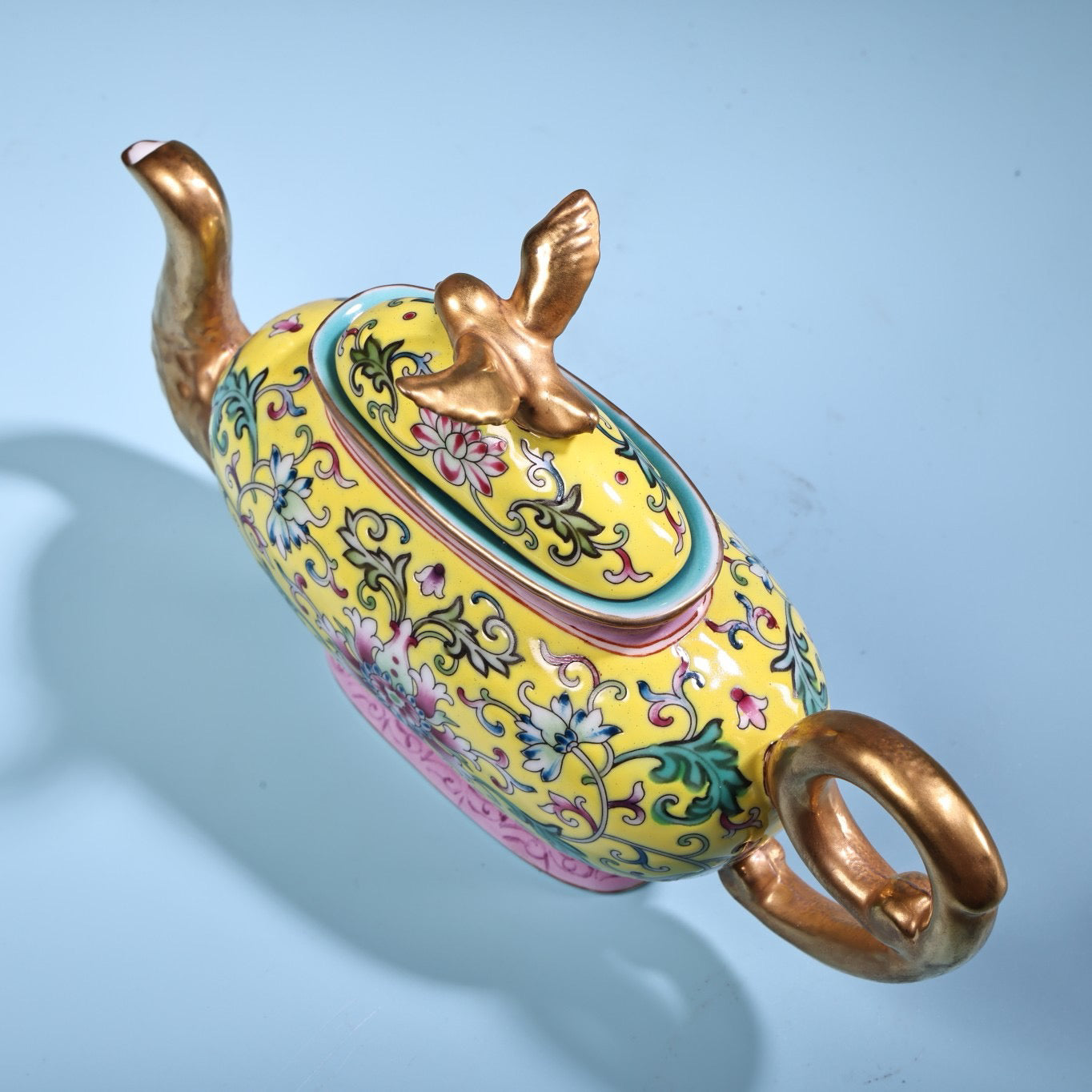 Hand painted enamel gilded gold colored porcelain teapot