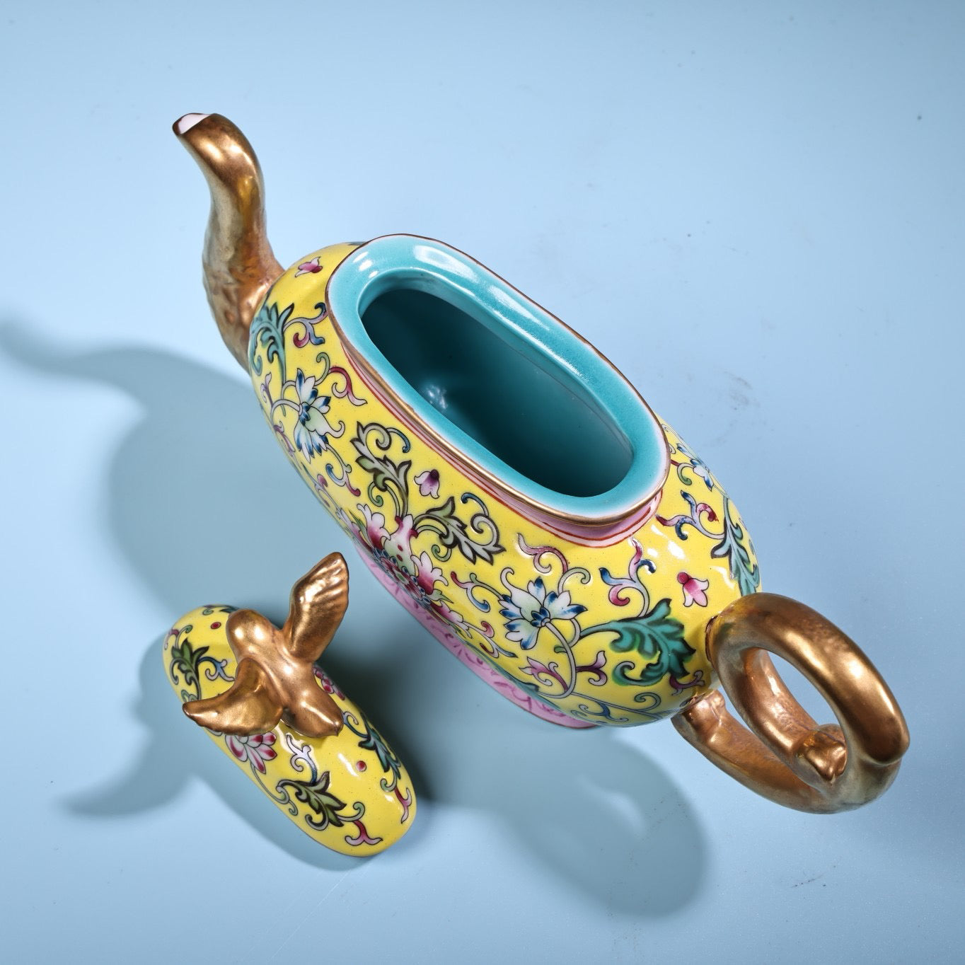 Hand painted enamel gilded gold colored porcelain teapot