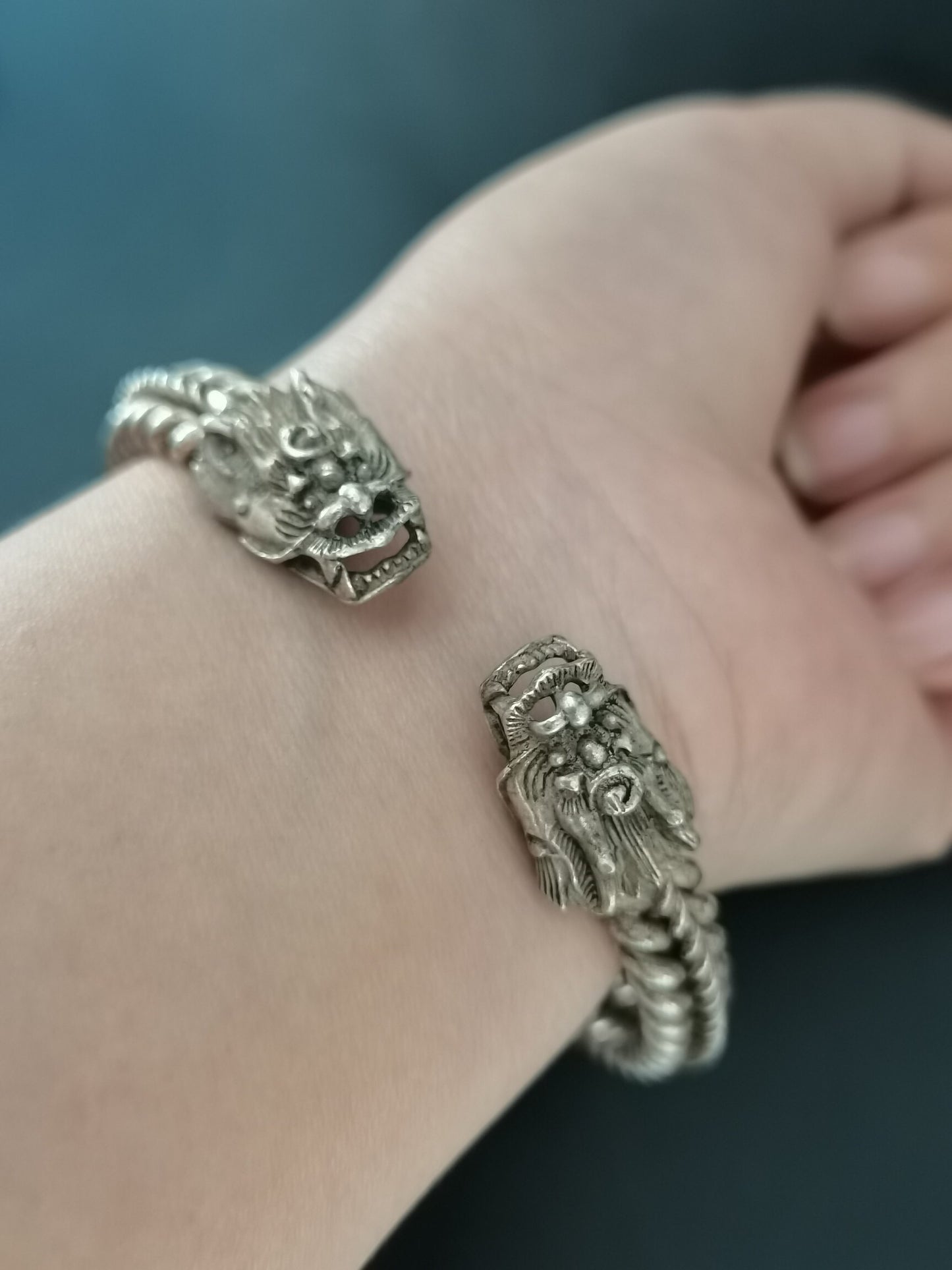 A pair of Chinese antique silver dragon head bracelets