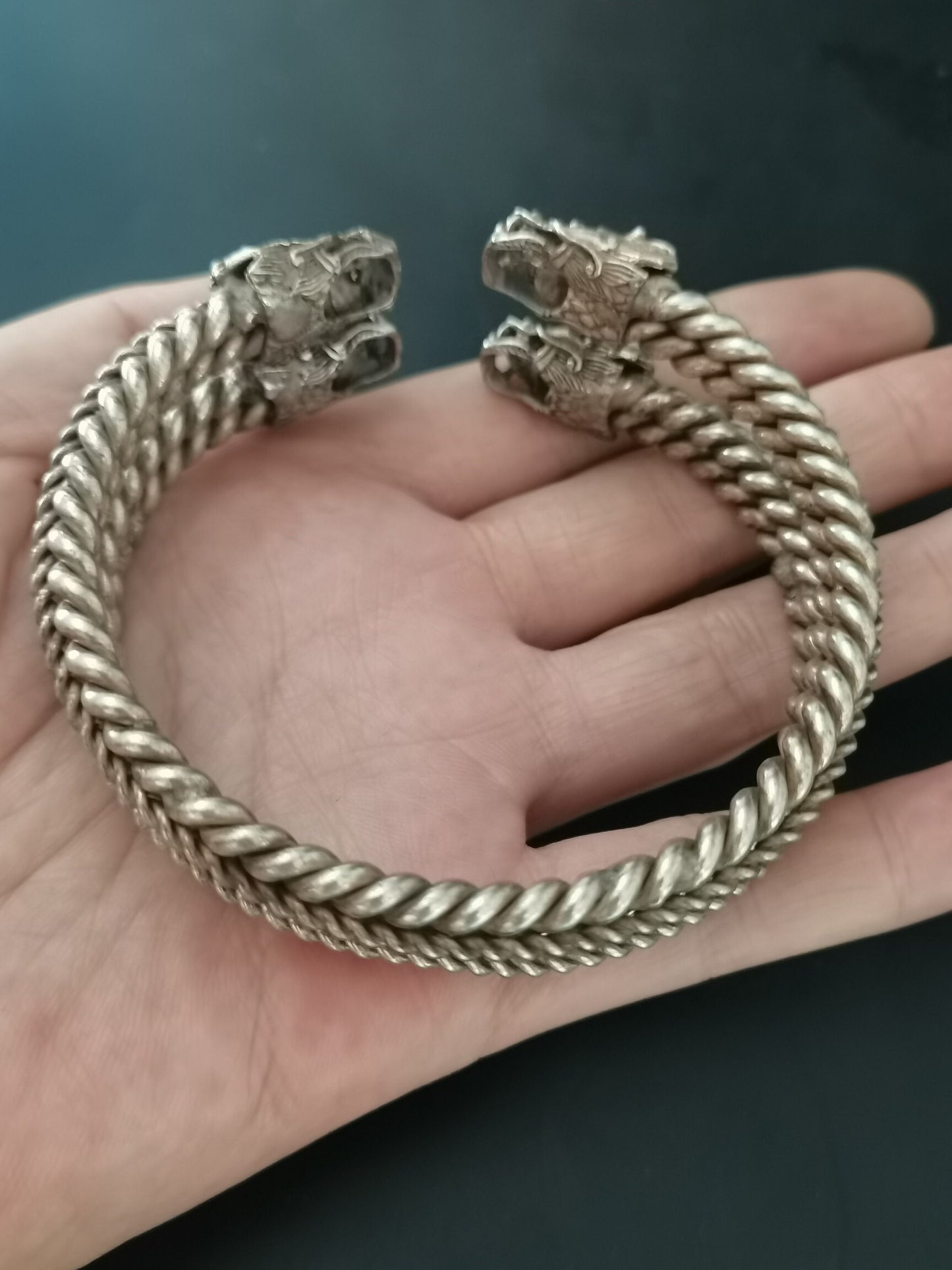 A pair of Chinese antique silver dragon head bracelets