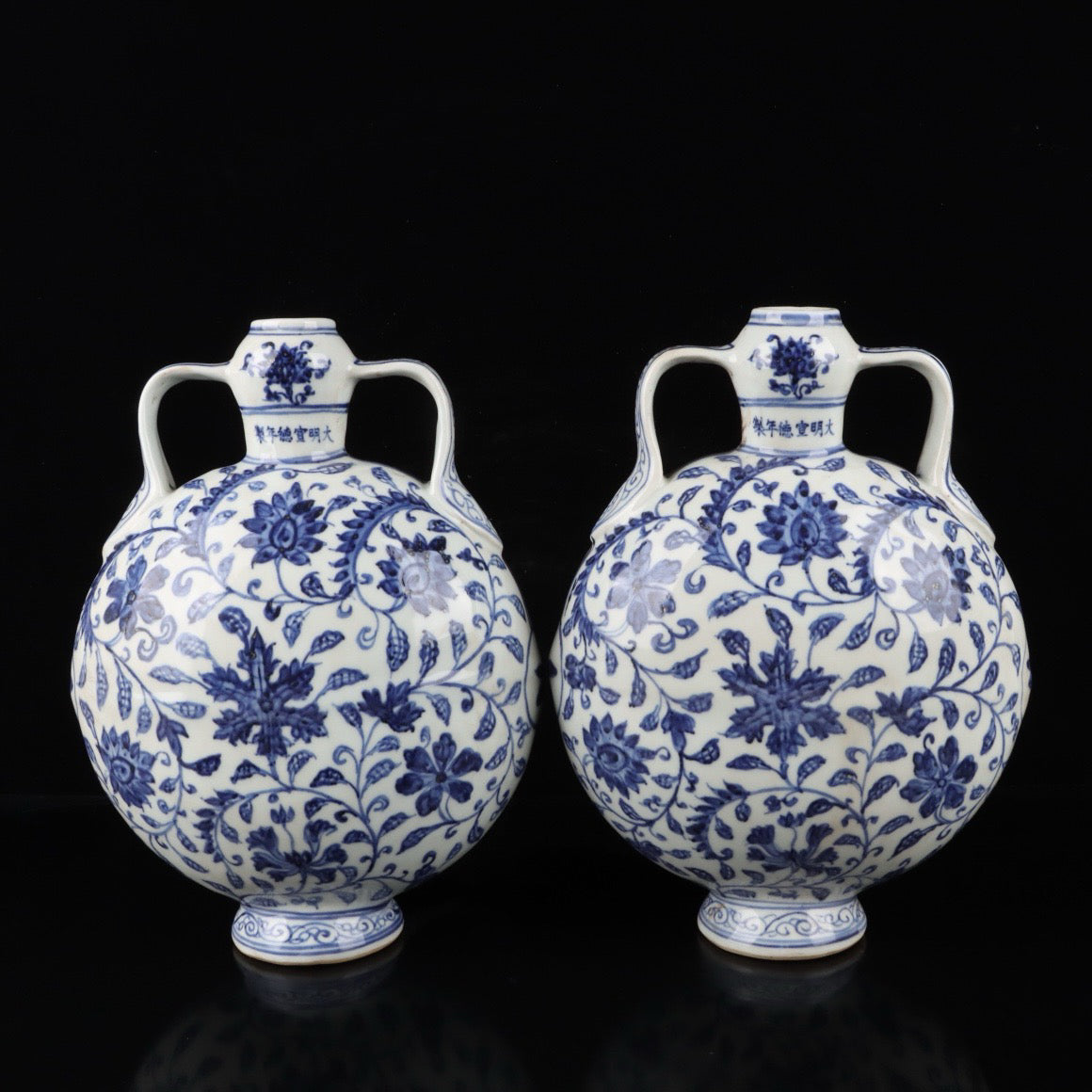 A pair of blue and white twisted branch lotus patterned double ear flat bottles