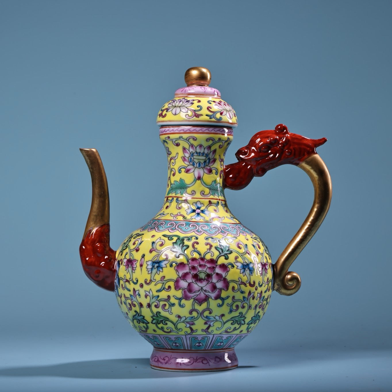 Hand painted enamel gilded gold colored porcelain teapot