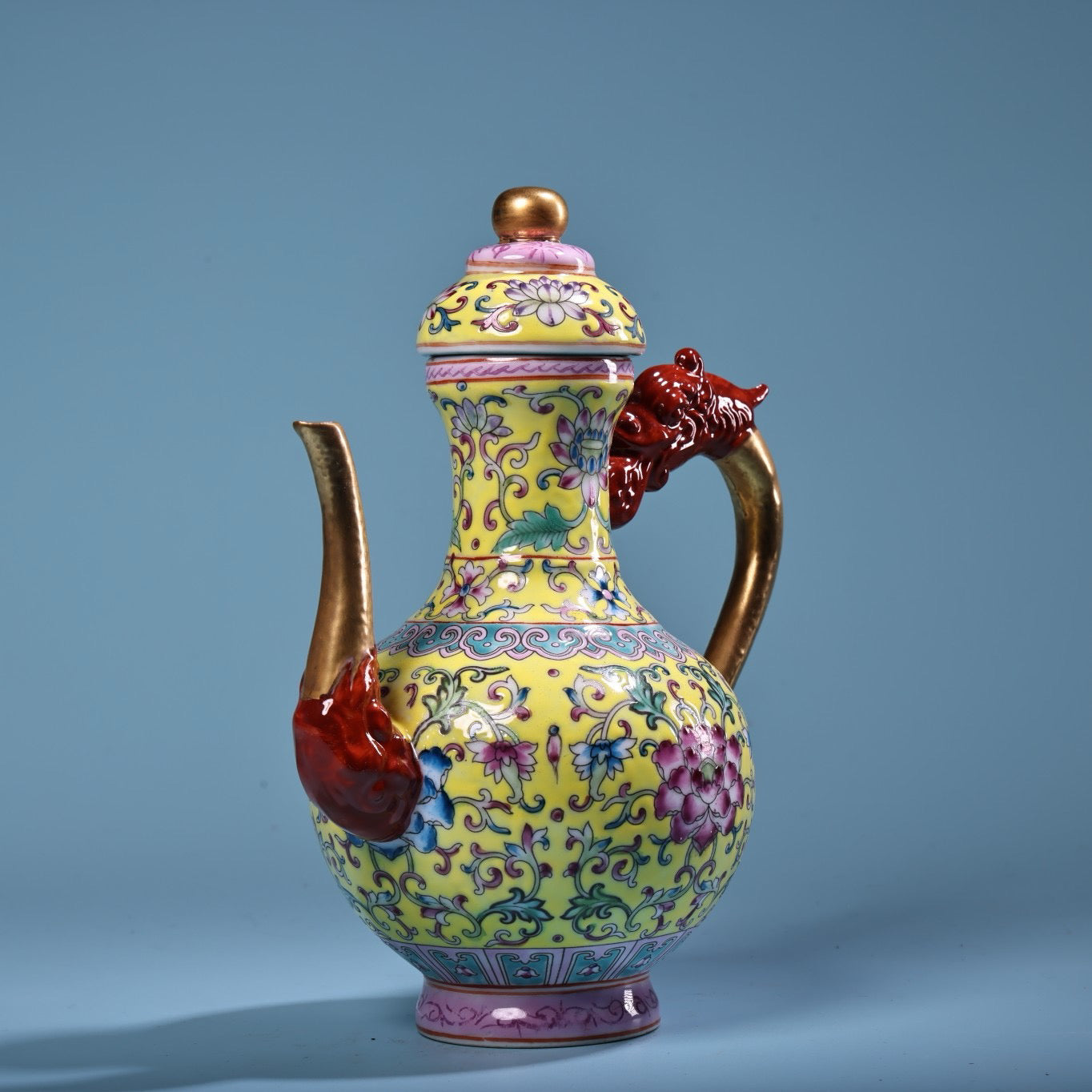 Hand painted enamel gilded gold colored porcelain teapot