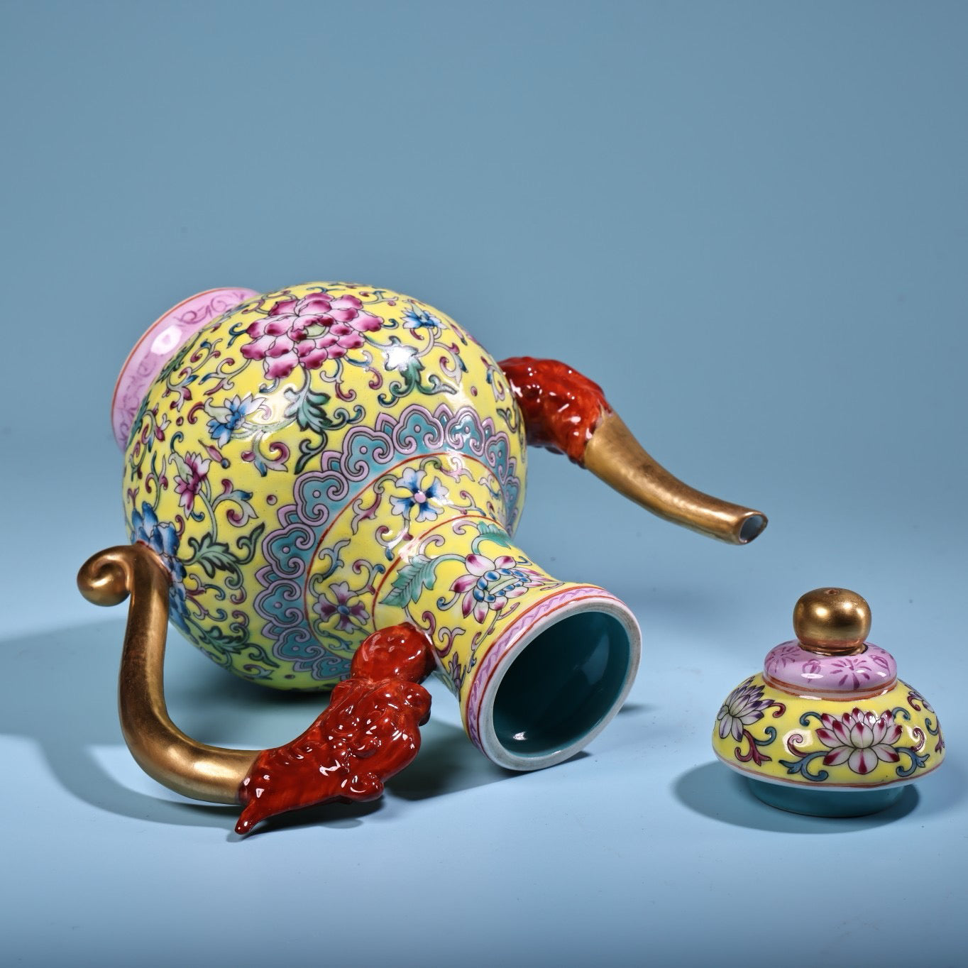Hand painted enamel gilded gold colored porcelain teapot