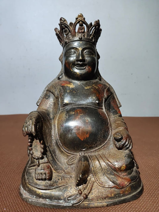 A statue of Maitreya Buddha with a large belly, made of copper, mud, gold, blooming, and sprinkled with cinnabar