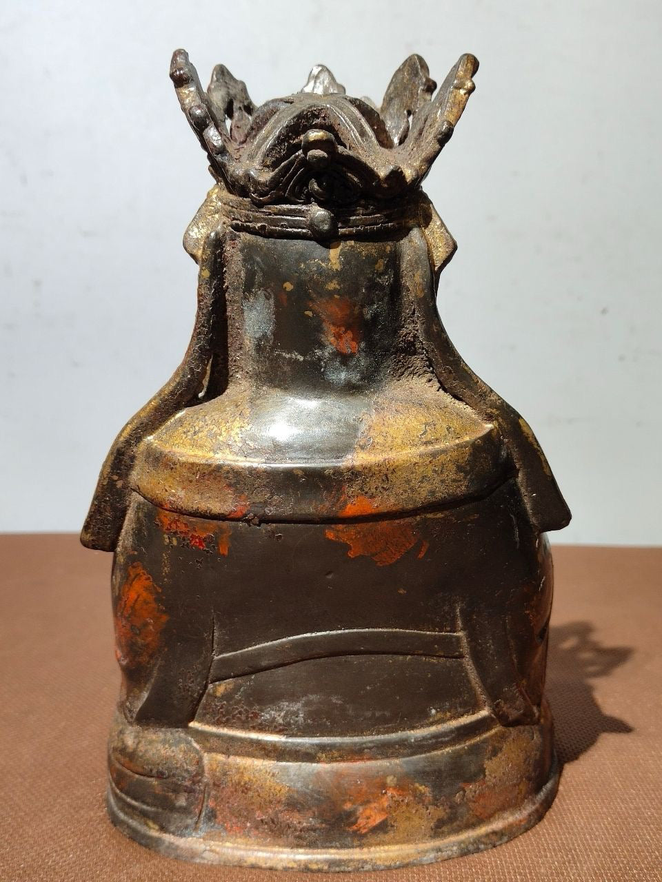 A statue of Maitreya Buddha with a large belly, made of copper, mud, gold, blooming, and sprinkled with cinnabar