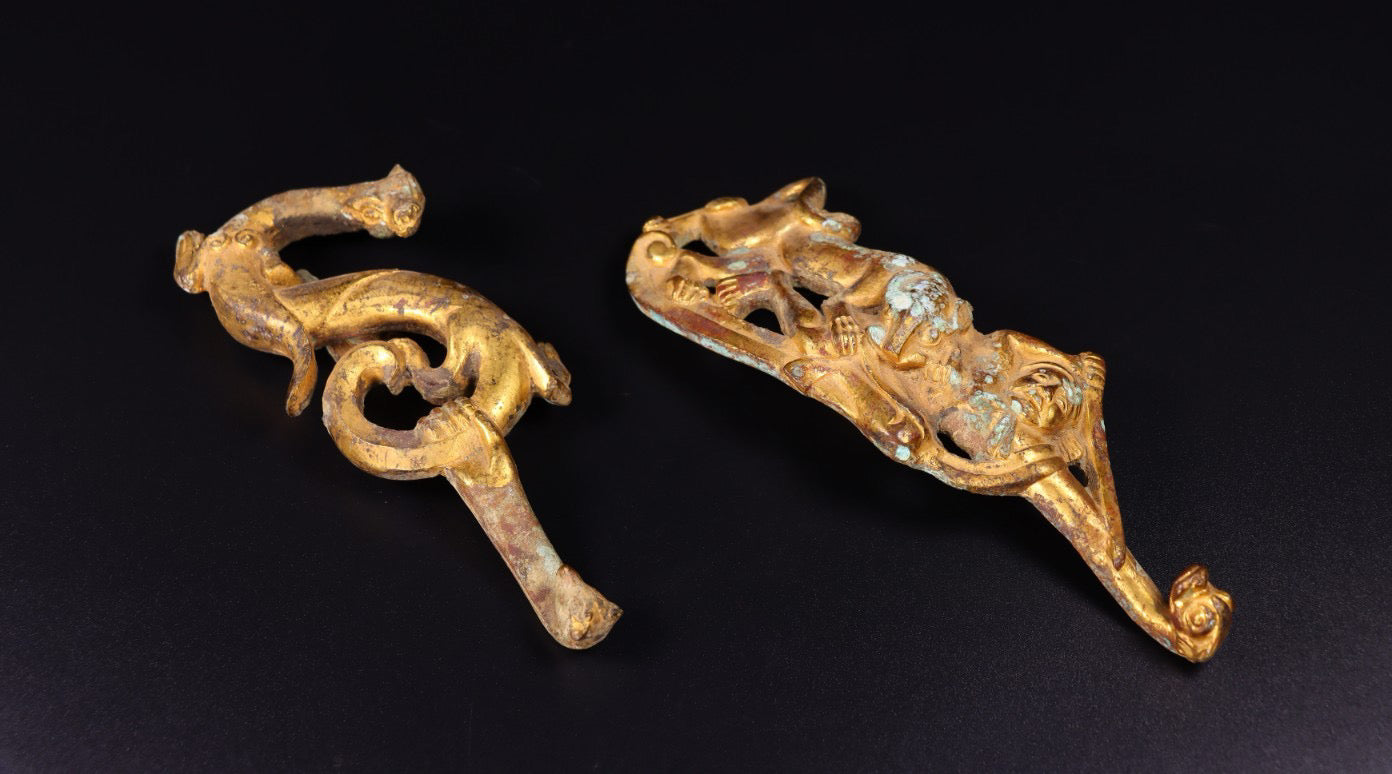 A pair of Chinese antique bronze gilded with red spots, green rust, and hooks