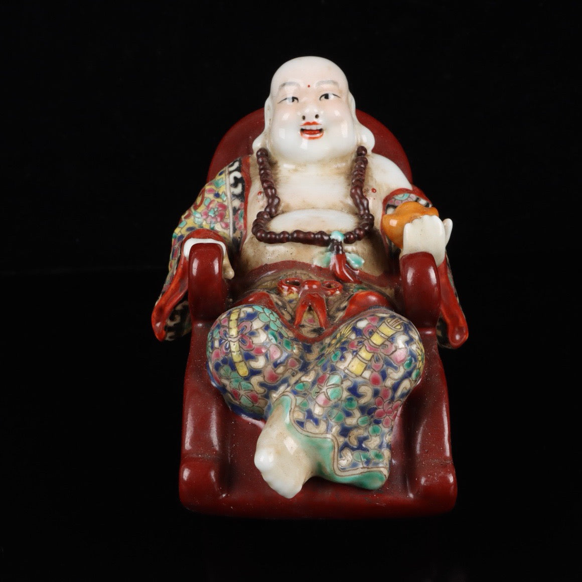 Pink rocking chair with big belly Buddha