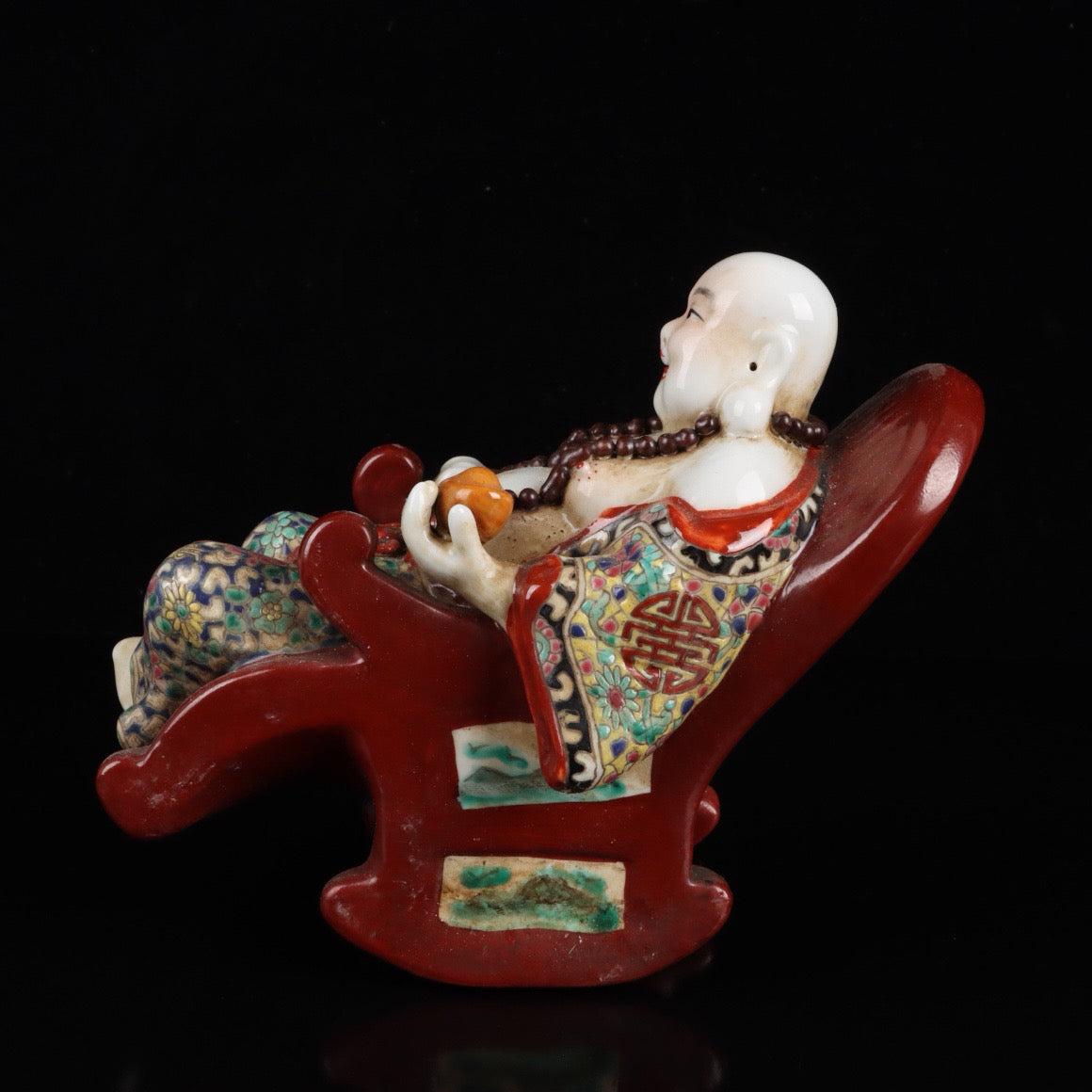 Pink rocking chair with big belly Buddha
