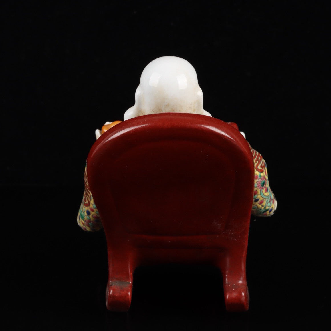 Pink rocking chair with big belly Buddha
