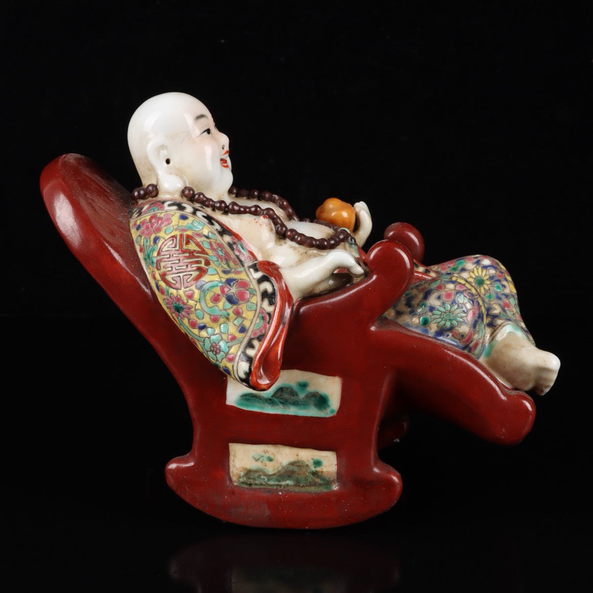 Pink rocking chair with big belly Buddha