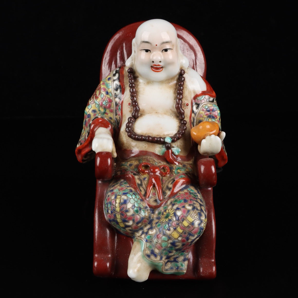 Pink rocking chair with big belly Buddha
