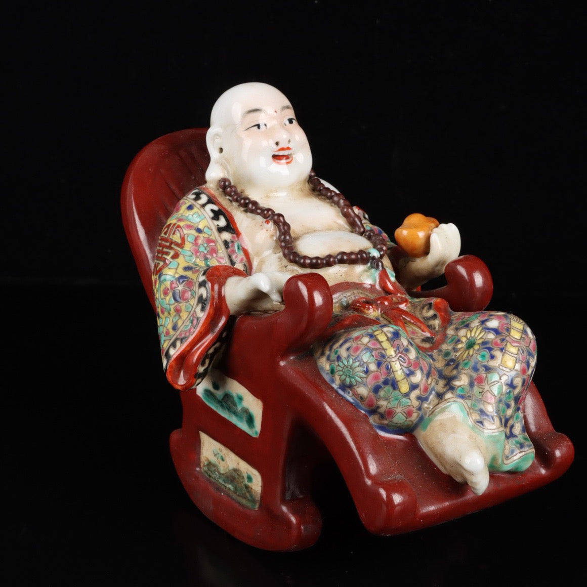 Pink rocking chair with big belly Buddha