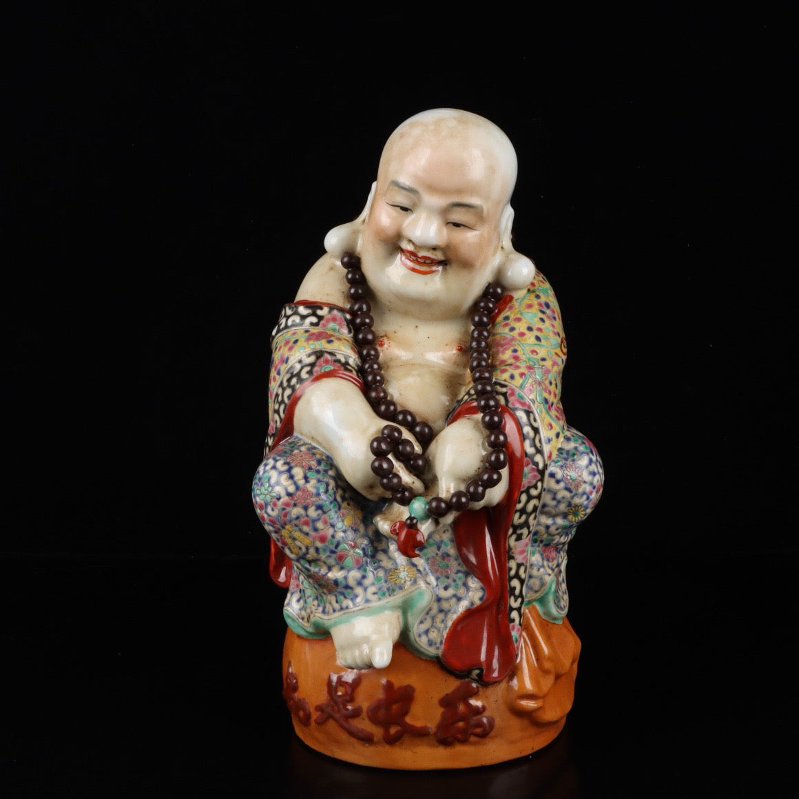 Pink contented and happy Buddha with a big belly