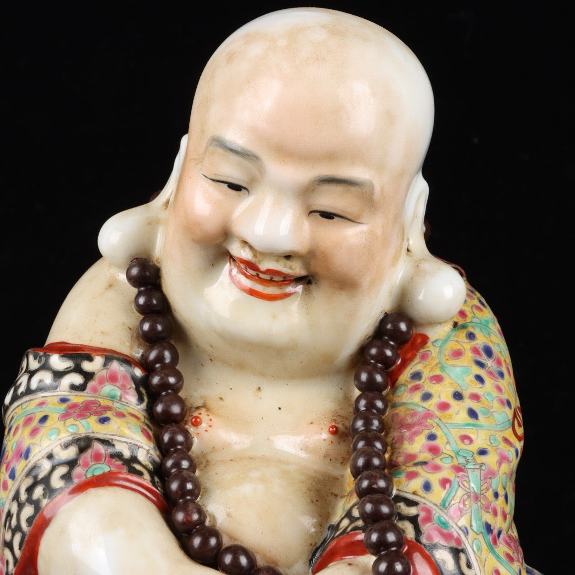 Pink contented and happy Buddha with a big belly