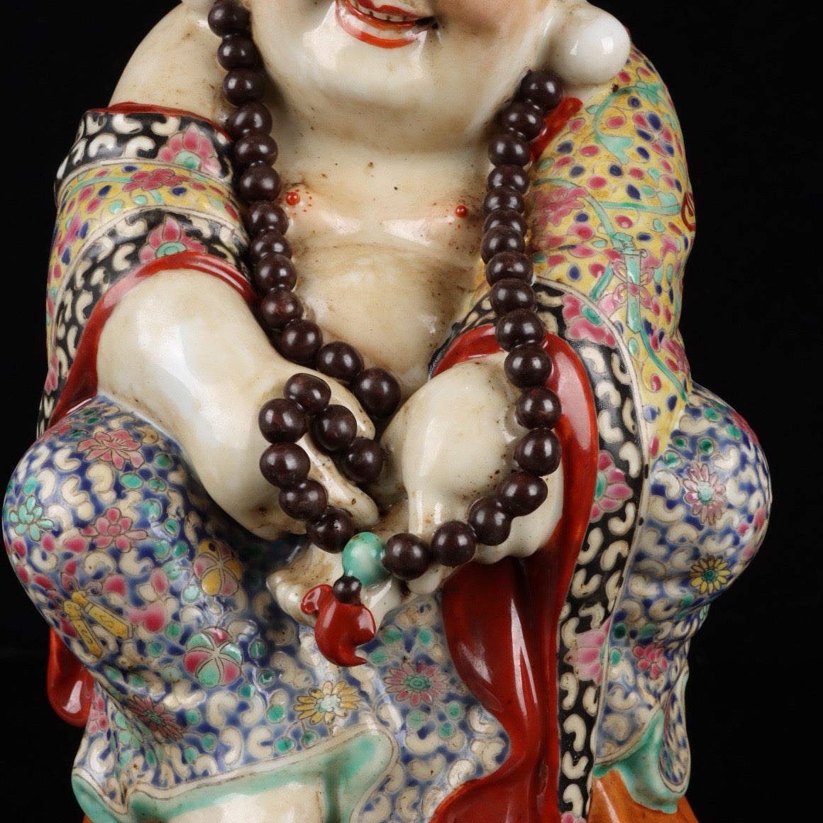 Pink contented and happy Buddha with a big belly
