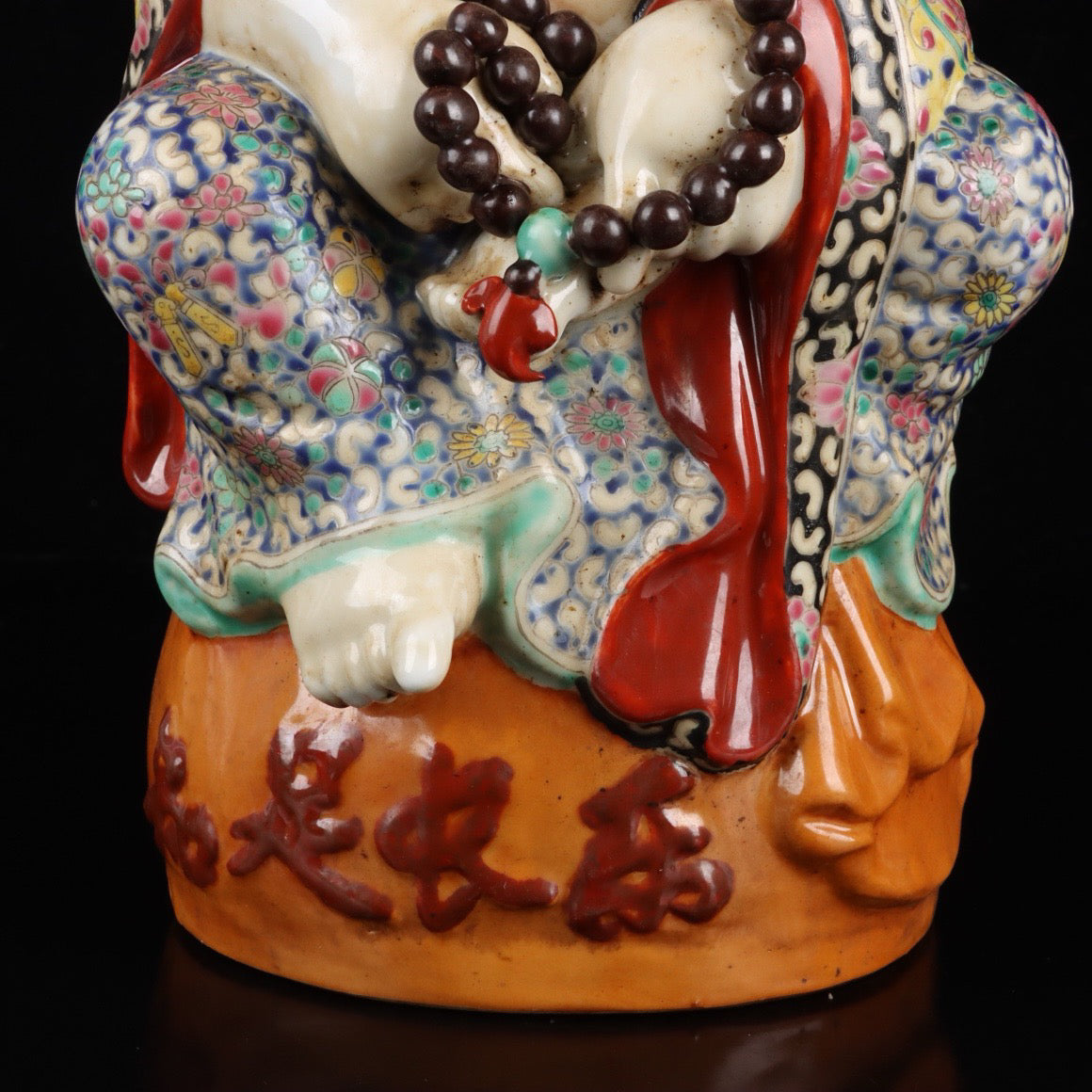 Pink contented and happy Buddha with a big belly
