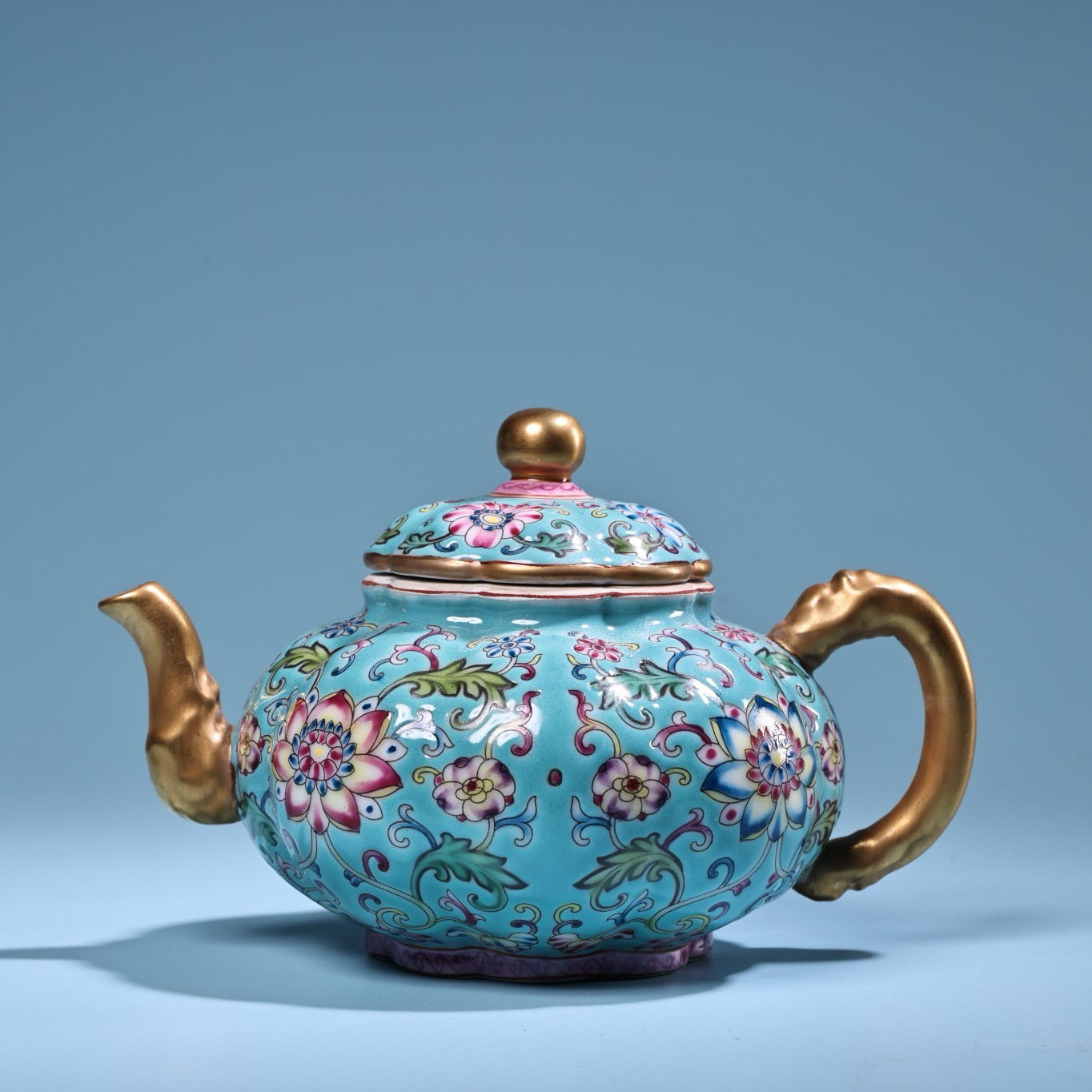 Enamel gilded gold colored porcelain teapot