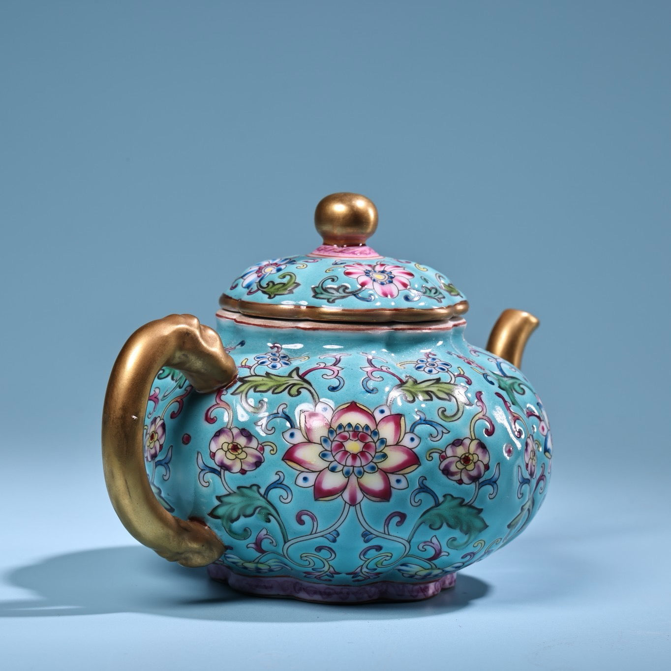 Enamel gilded gold colored porcelain teapot