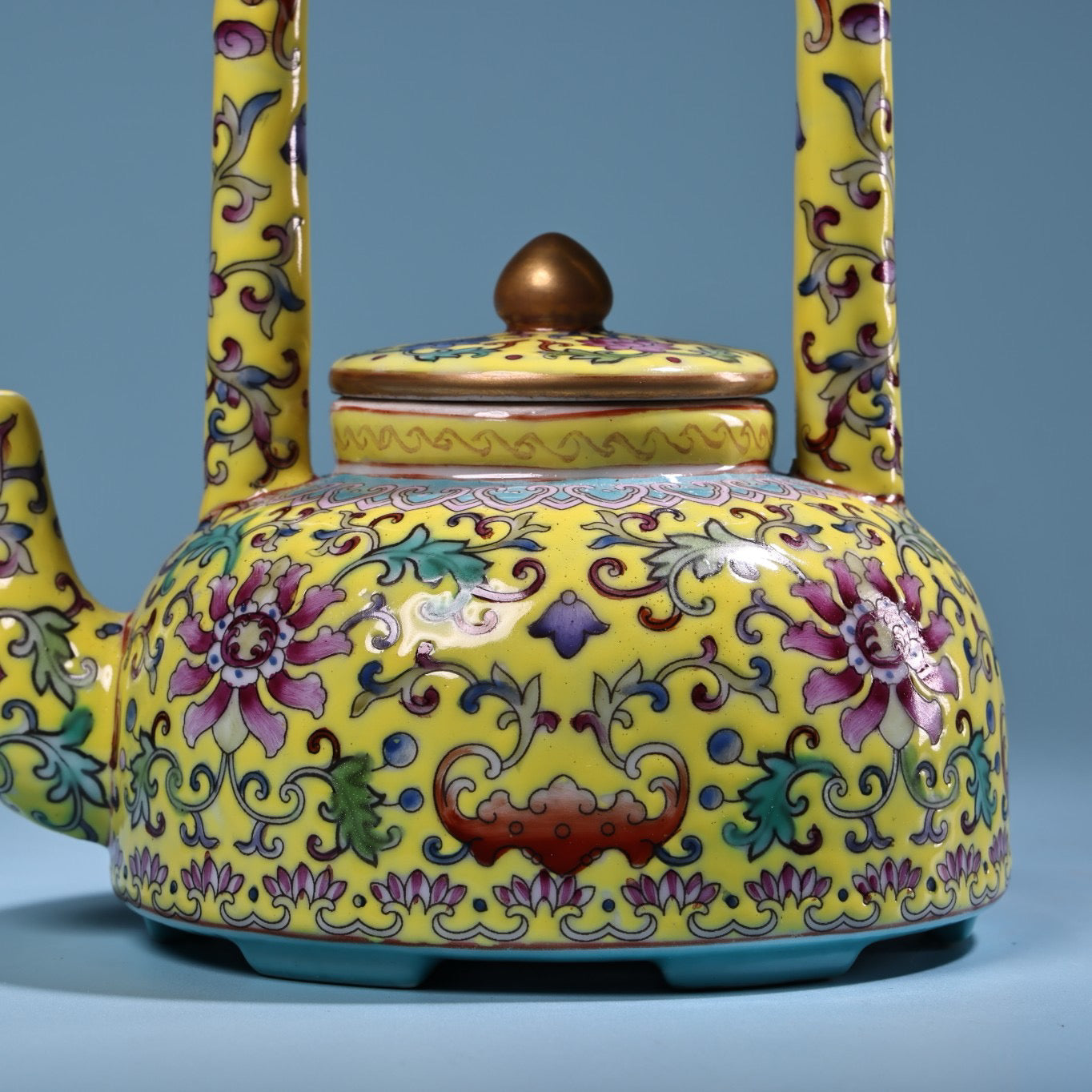 Hand painted enamel gilded gold colored porcelain lifting beam teapot