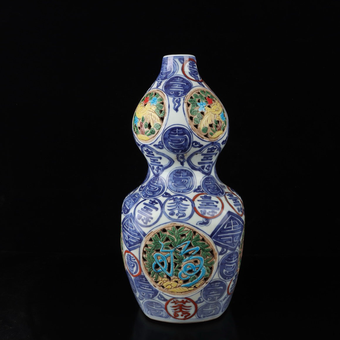 Blue and white hollowed out gourd vase with colorful longevity patterns