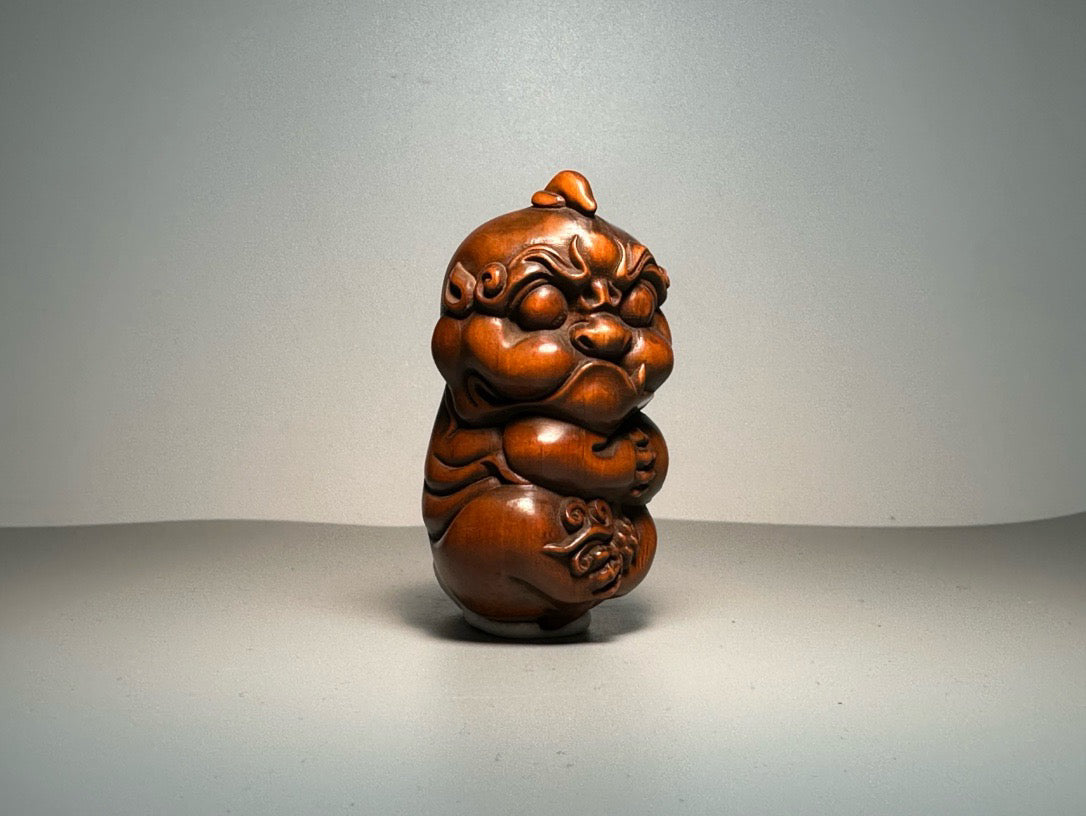 Chinese antique boxwood carving with exquisite craftsmanship, featuring a unicorn Pixiu holding a ball