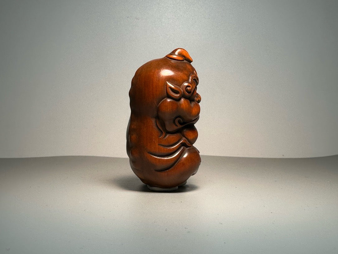 Chinese antique boxwood carving with exquisite craftsmanship, featuring a unicorn Pixiu holding a ball