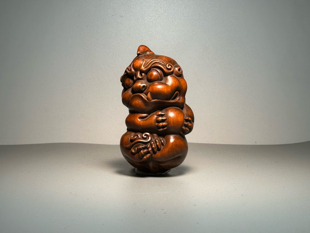 Chinese antique boxwood carving with exquisite craftsmanship, featuring a unicorn Pixiu holding a ball