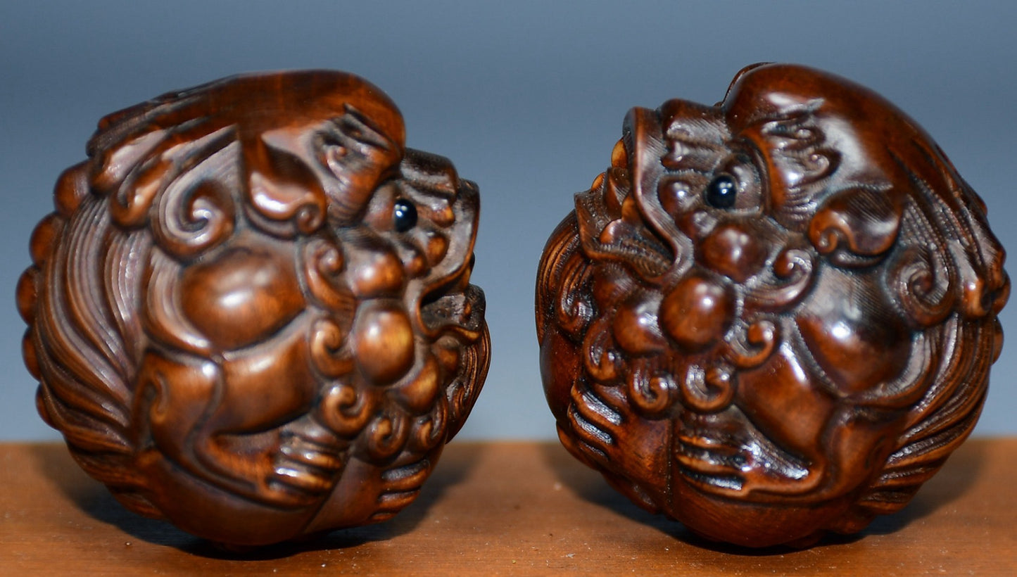 Collection of boxwood carved lion pairs of decorative health balls