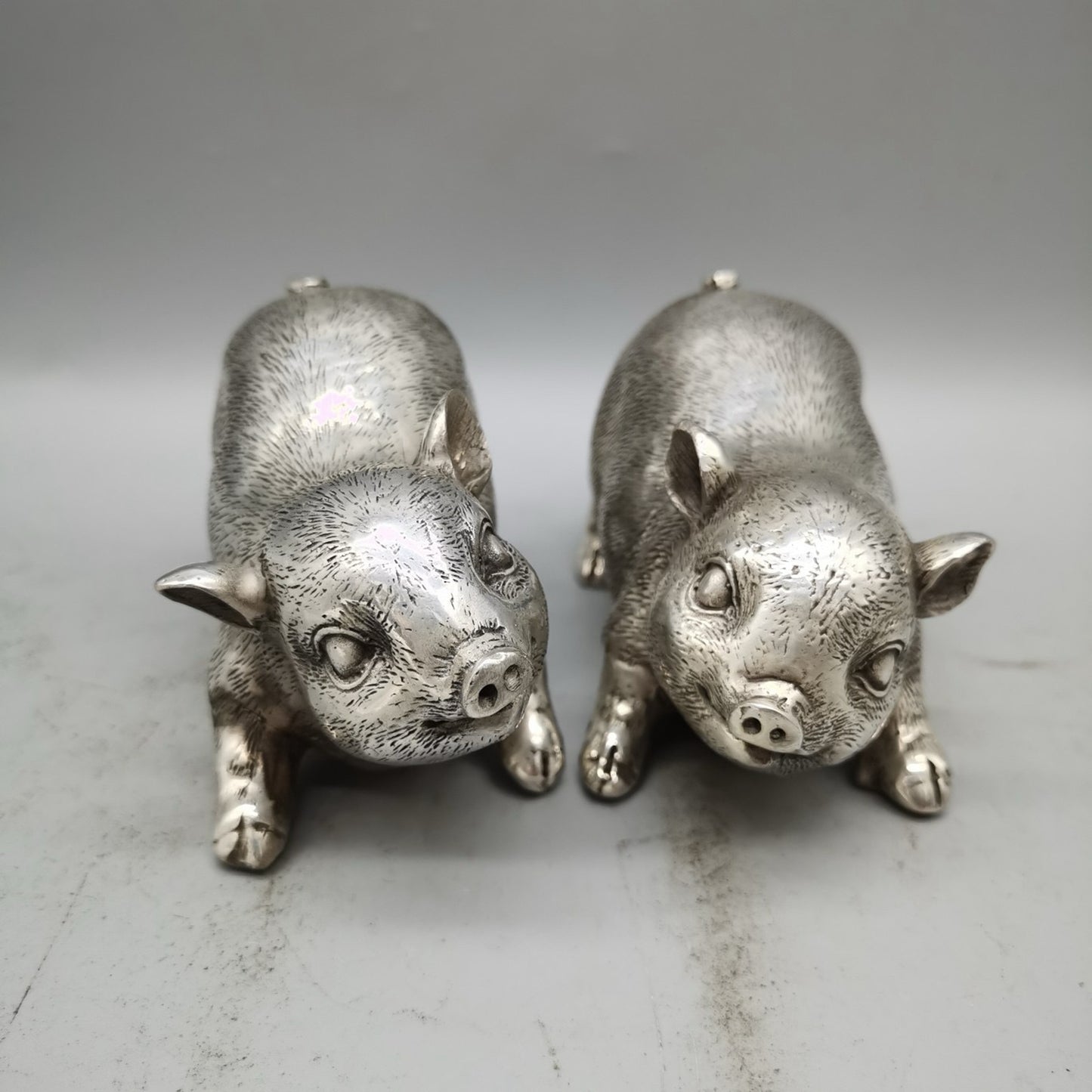 A pair of Chinese pure copper silver plated piglets for home and living room decoration