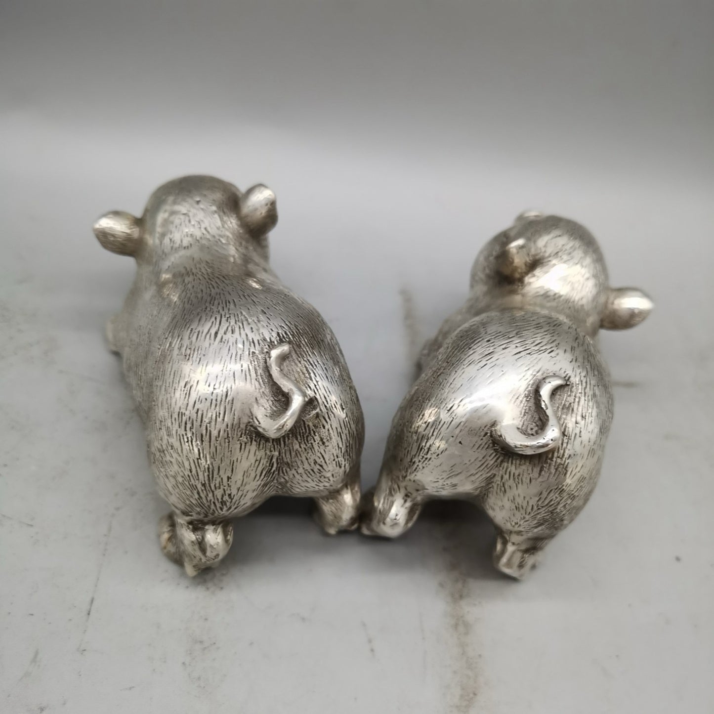 A pair of Chinese pure copper silver plated piglets for home and living room decoration