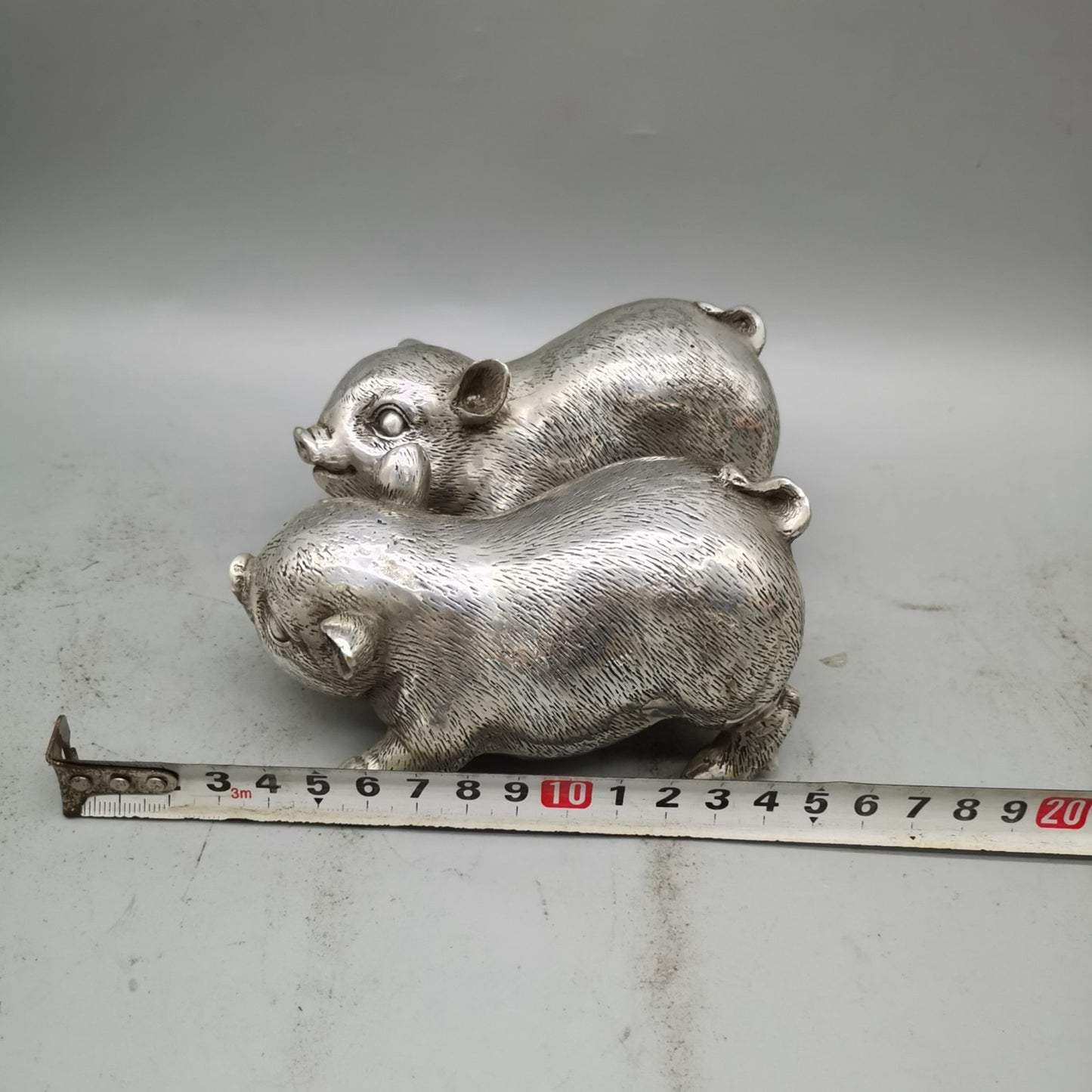 A pair of Chinese pure copper silver plated piglets for home and living room decoration