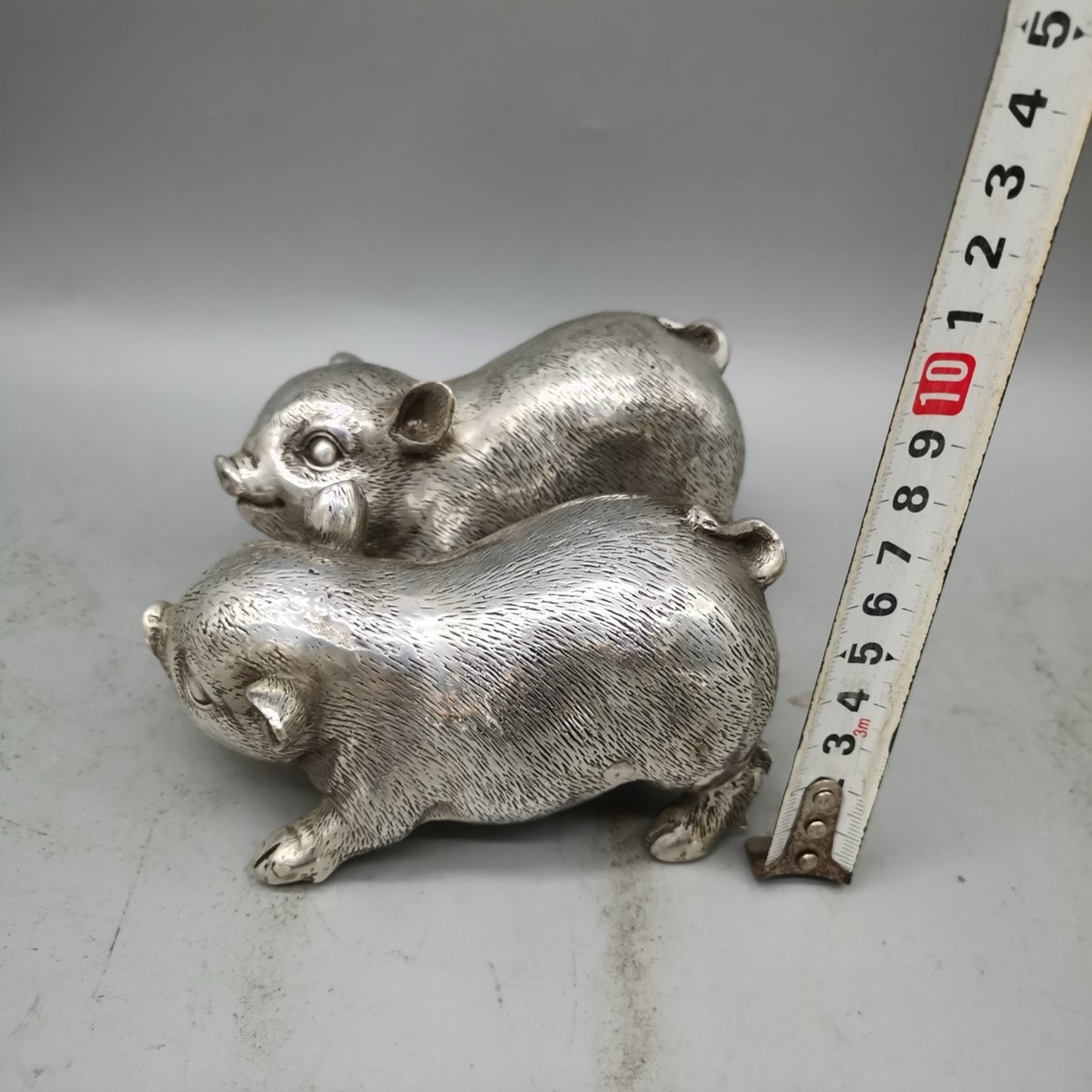 A pair of Chinese pure copper silver plated piglets for home and living room decoration