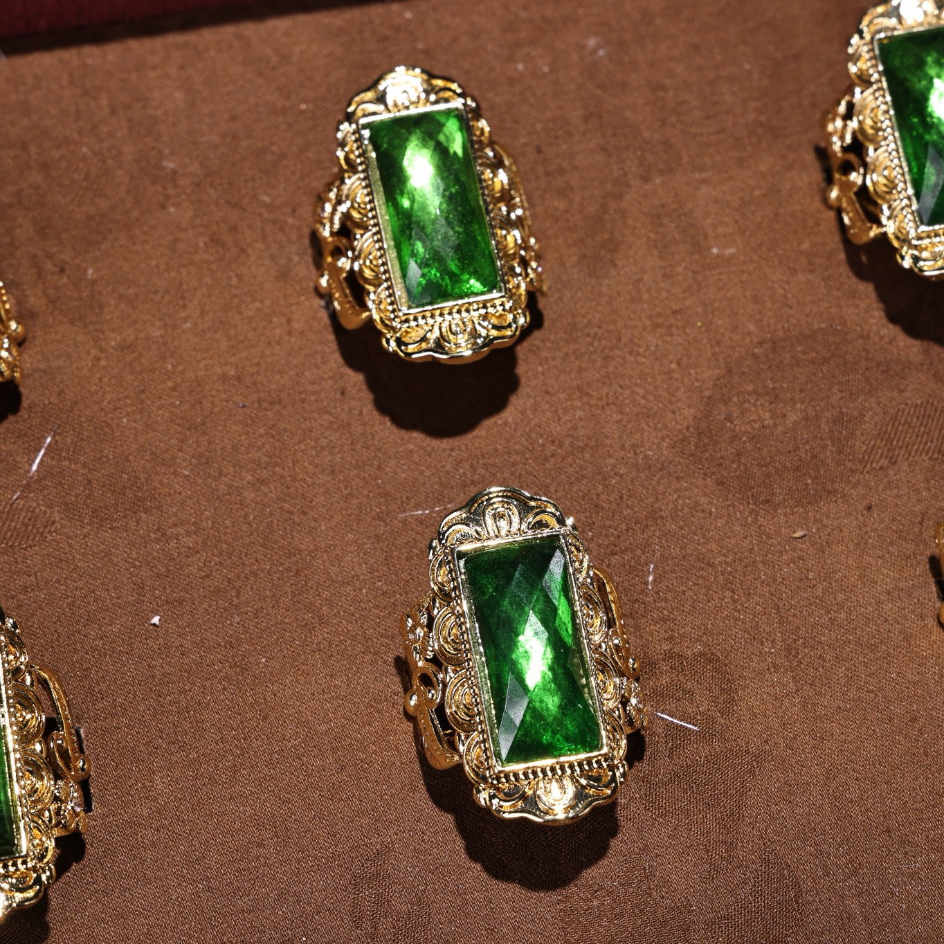 A box of Chinese antique cloisonne grandmother emerald rings