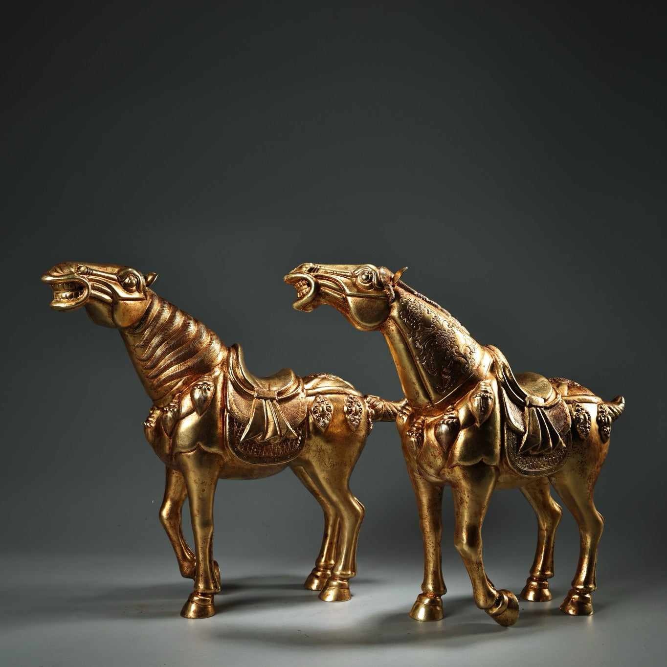 A pair of Chinese antique pure copper high relief carved and gilded Tang horses