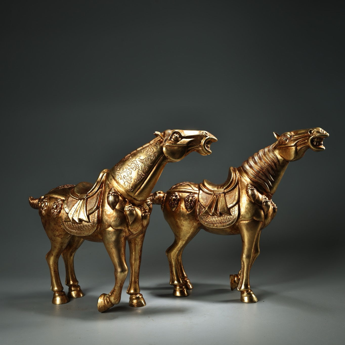 A pair of Chinese antique pure copper high relief carved and gilded Tang horses