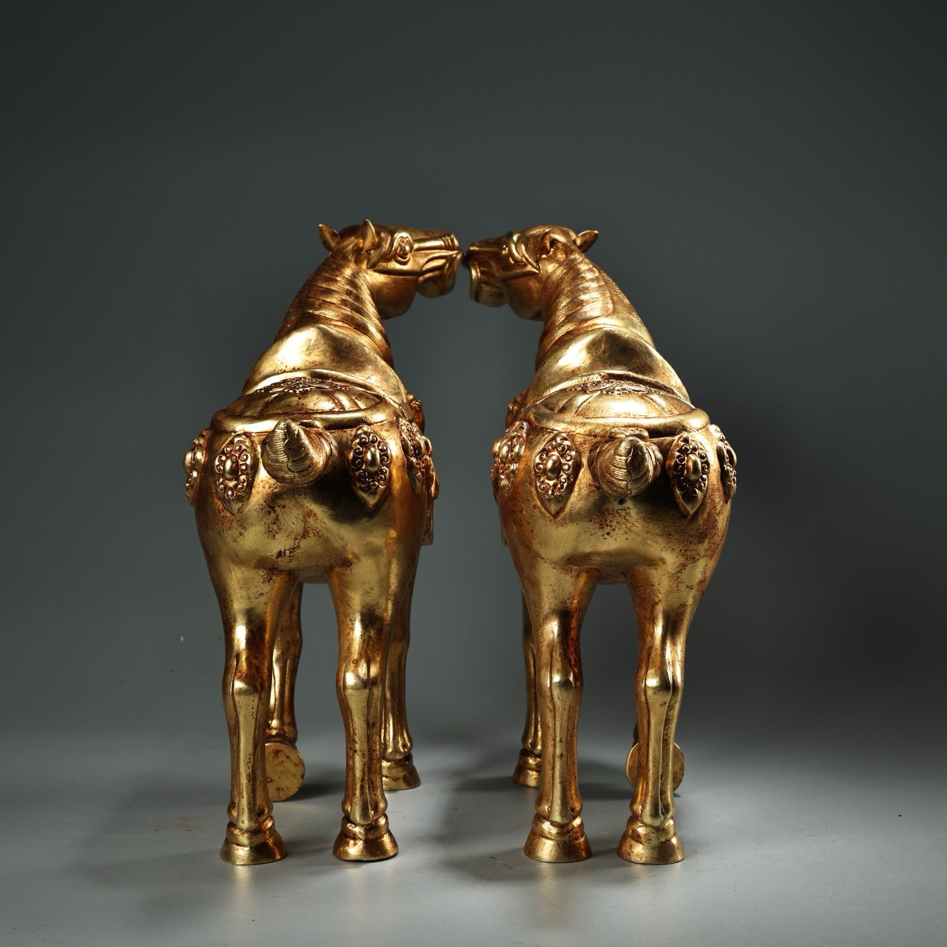 A pair of Chinese antique pure copper high relief carved and gilded Tang horses