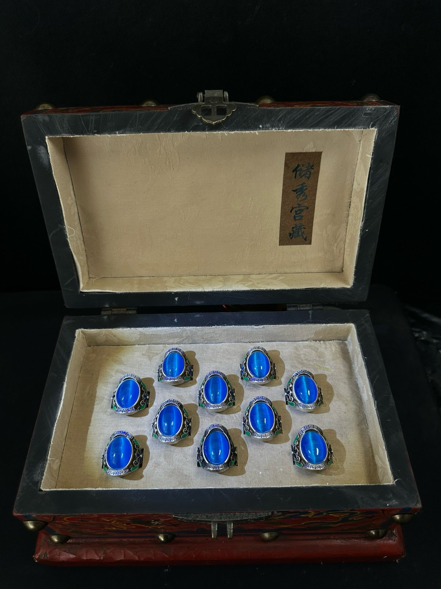 A box of Chinese antique blue cat eye rings